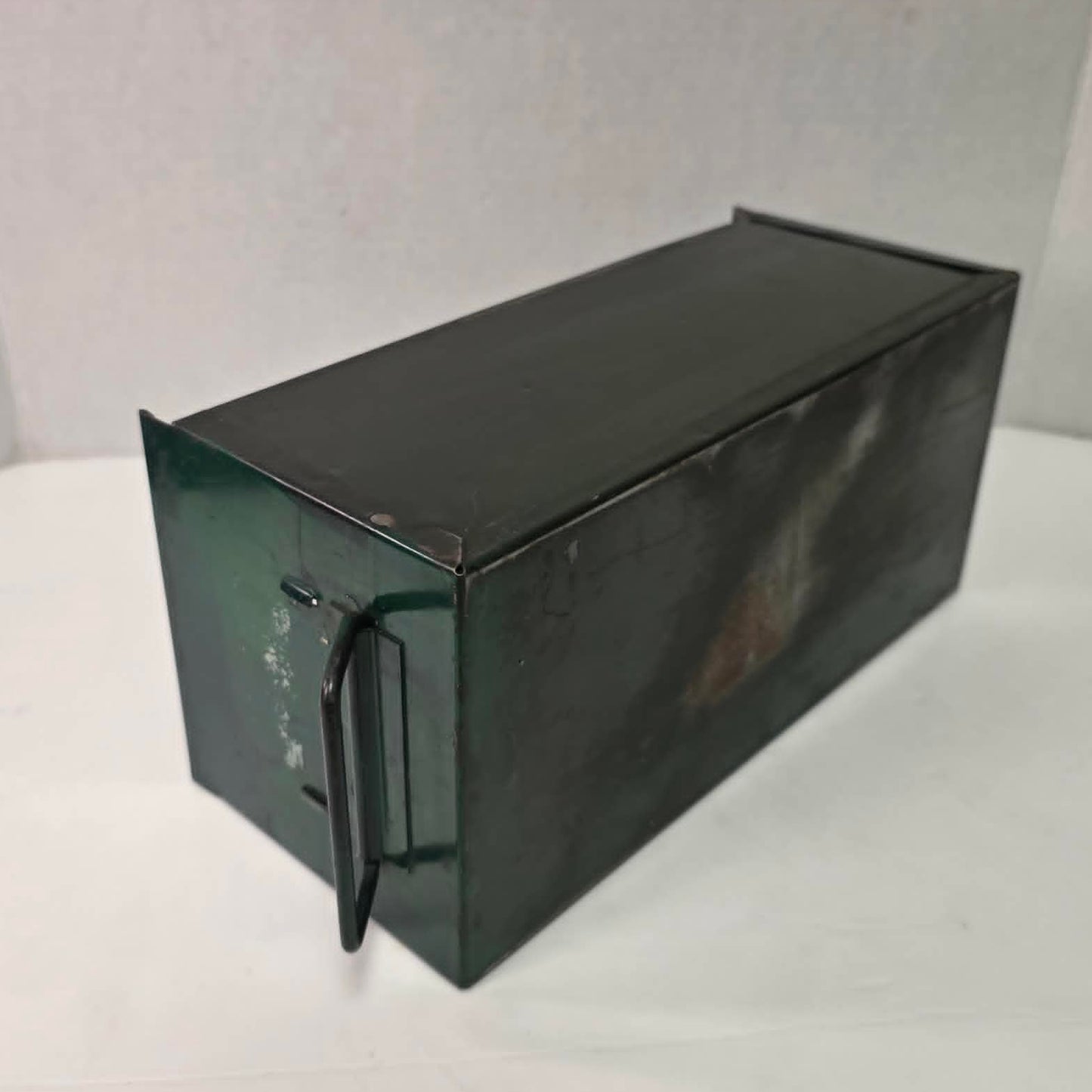 Antique industrial apothecary drawer with bail handle and label holder, vintage storage bin with aged patina.
