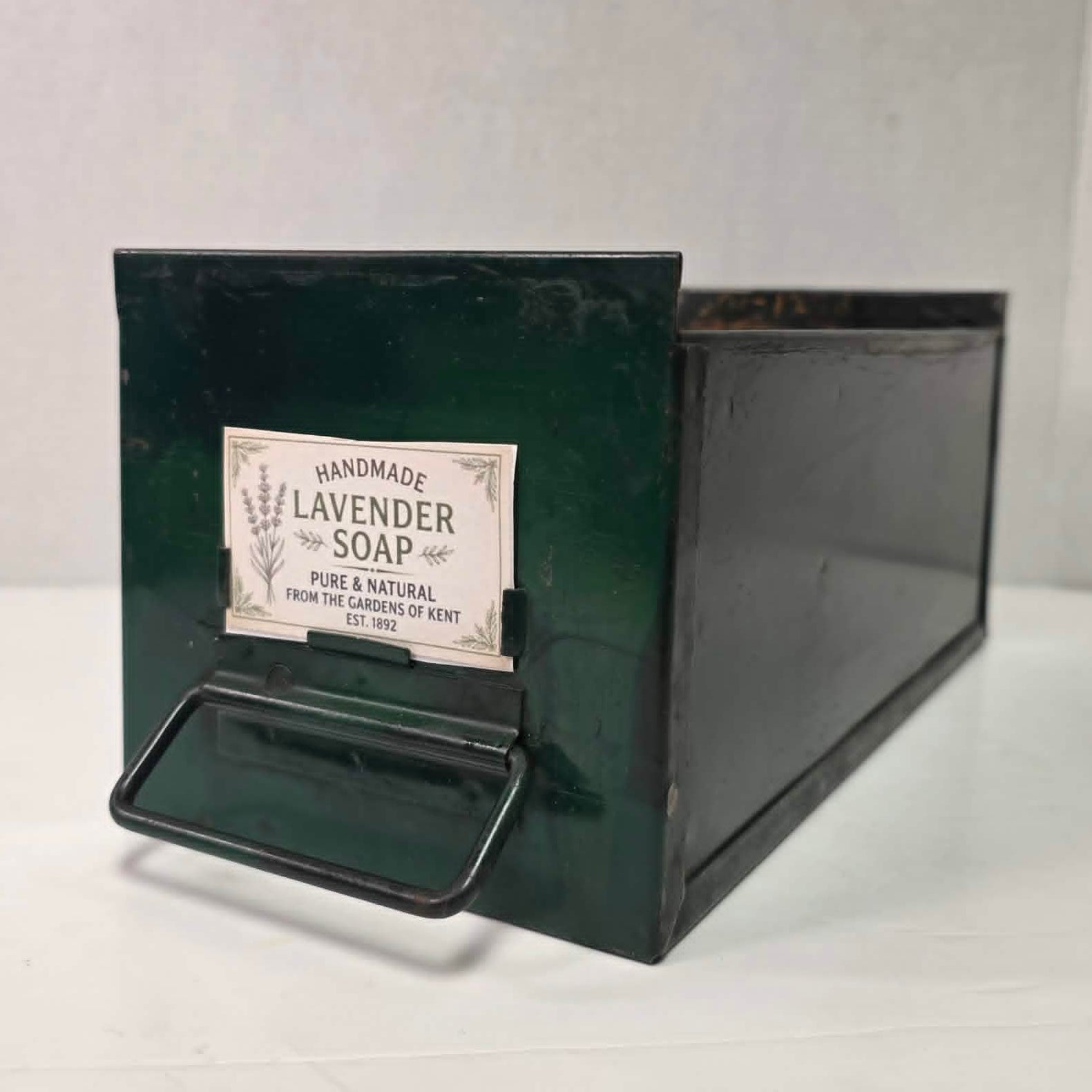 Antique industrial apothecary drawer with bail handle and label holder, vintage storage bin with aged patina.