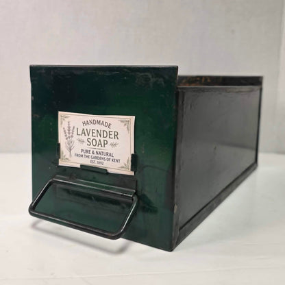 Antique industrial apothecary drawer with bail handle and label holder, vintage storage bin with aged patina.