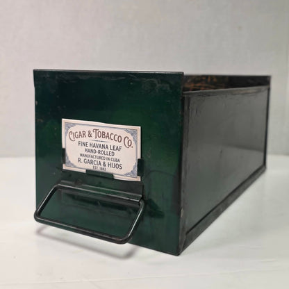Antique industrial apothecary drawer with bail handle and label holder, vintage storage bin with aged patina.