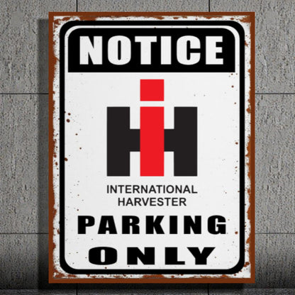 Vintage-style metal sign with 'Notice International Harvester Parking Only' text on a textured wall background.