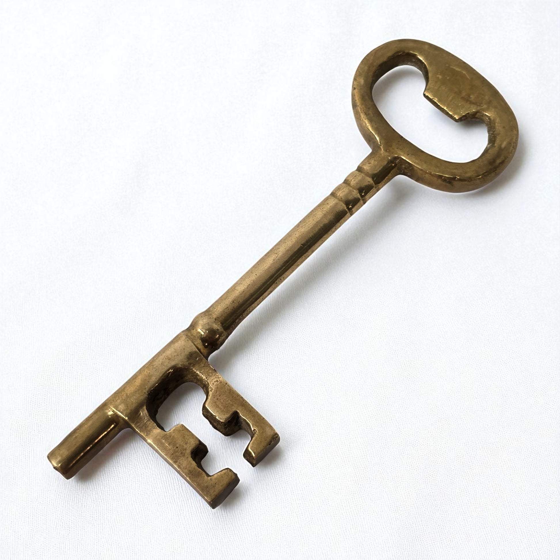 Bronze key on a white background