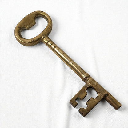 Vintage brass key on a white background