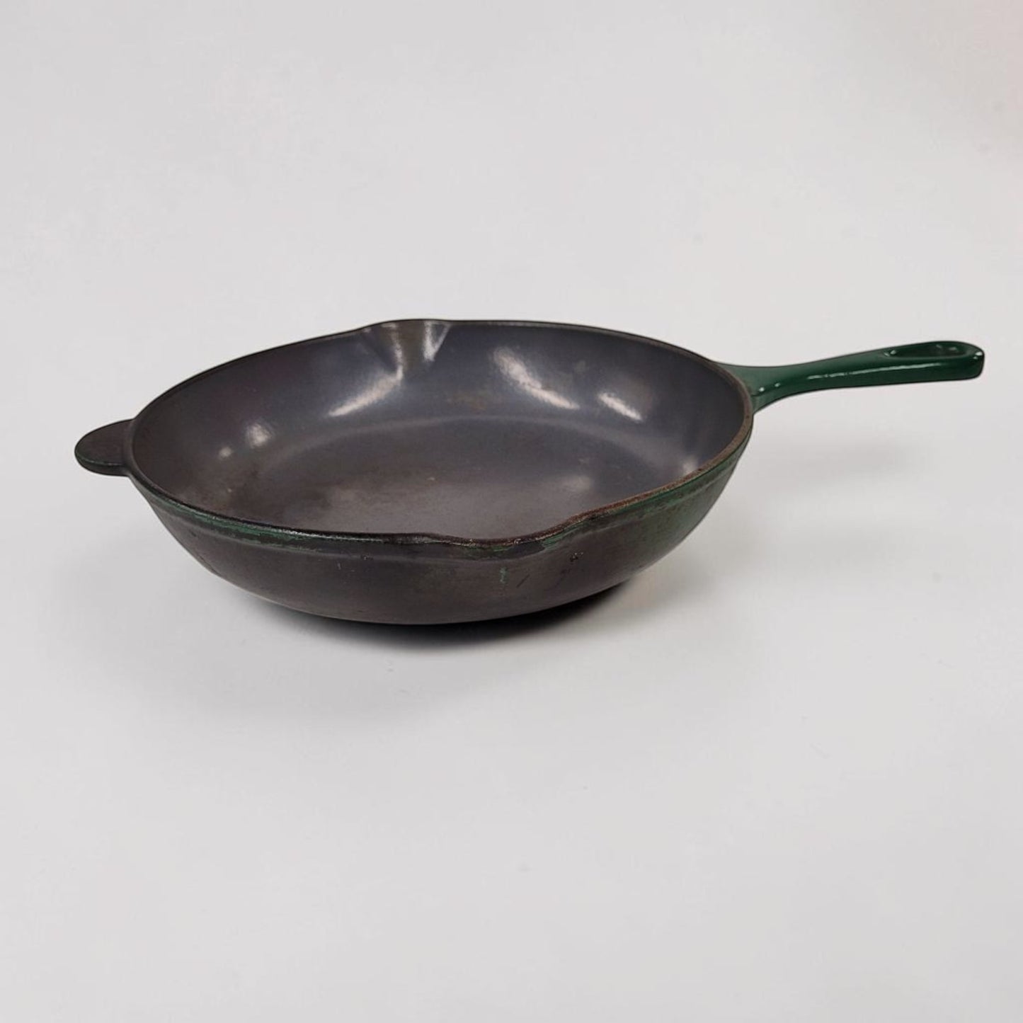 Vintage green Le Creuset No. 23 cast iron frying pan made in France.

