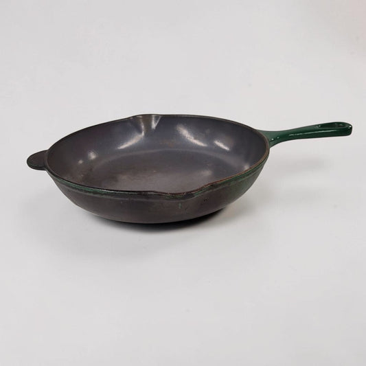 Vintage green Le Creuset No. 23 cast iron frying pan made in France.
