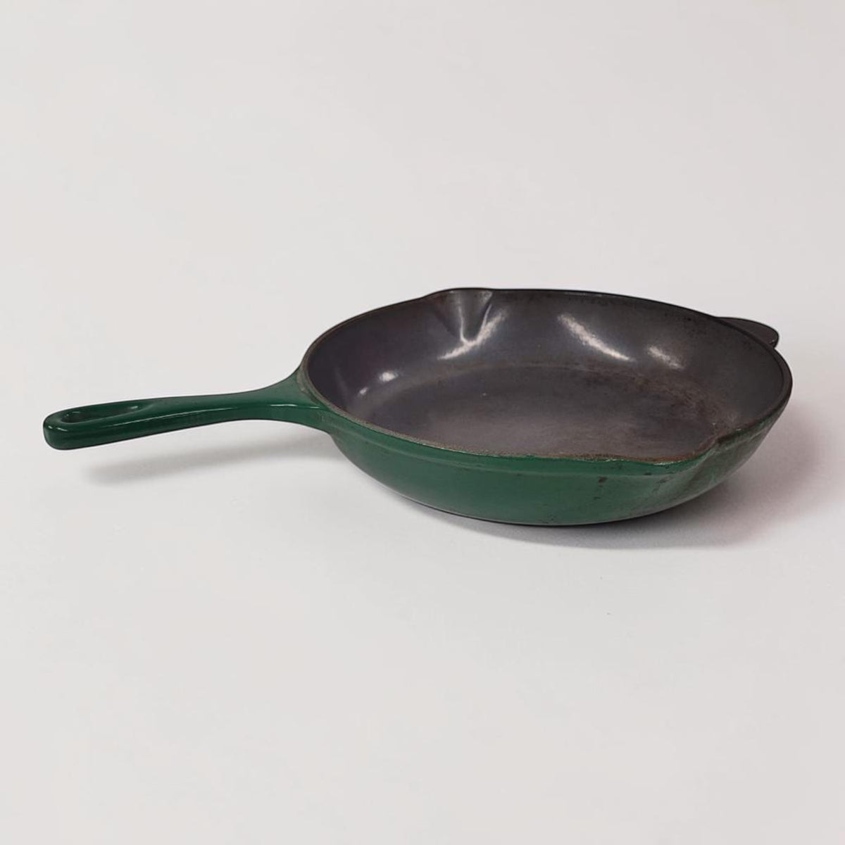 Vintage green Le Creuset No. 23 cast iron frying pan made in France.
