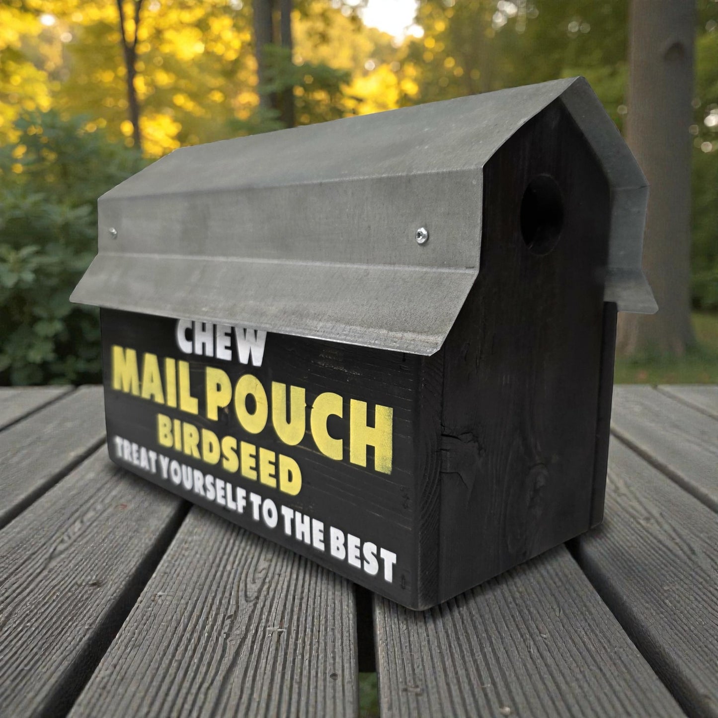 Birdseed container with text on a wooden surface outdoors