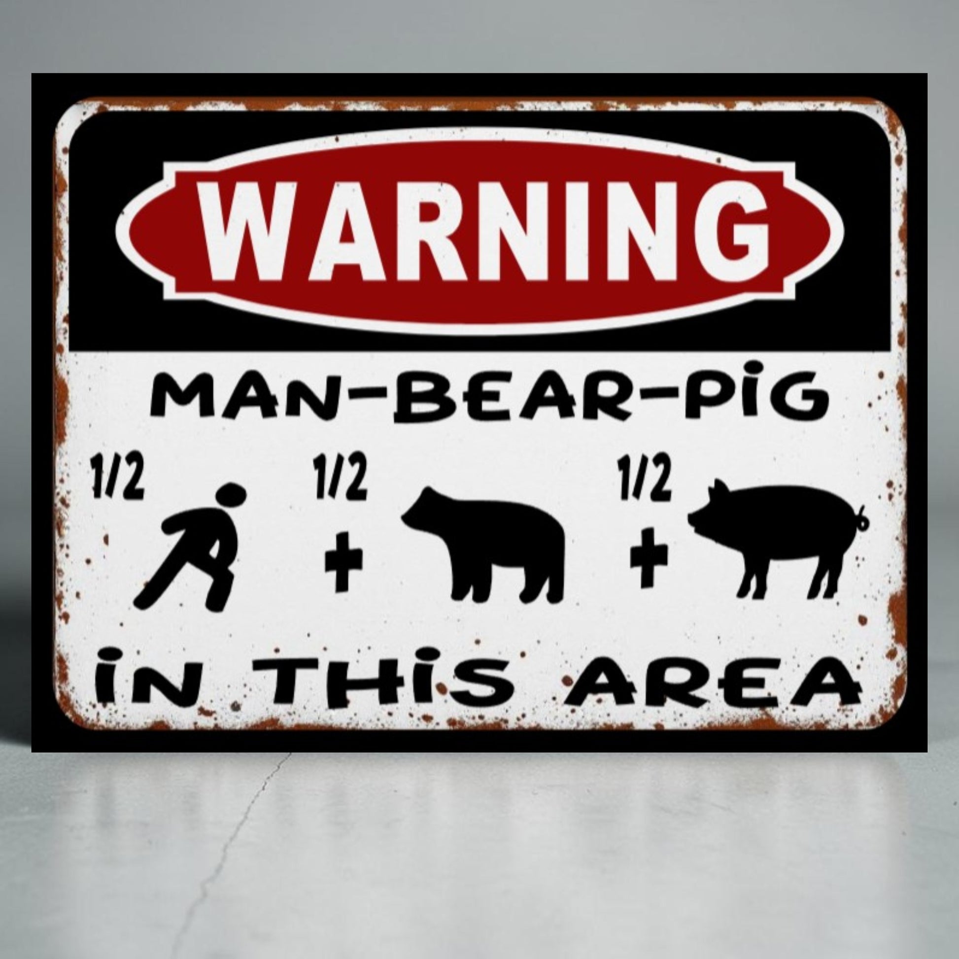Metal sign with 'WARNING: MAN-BEAR-PIG IN THIS AREA' text and symbols on a gray background