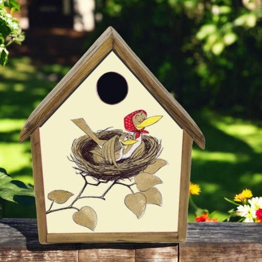 Wooden birdhouse with a painted design of birds in a nest on a natural background