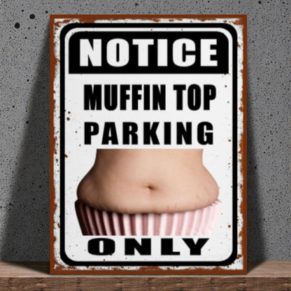 Metal sign with a graphic of a muffin top and text 'Notice Muffin Top Parking Only' on a textured wall background.