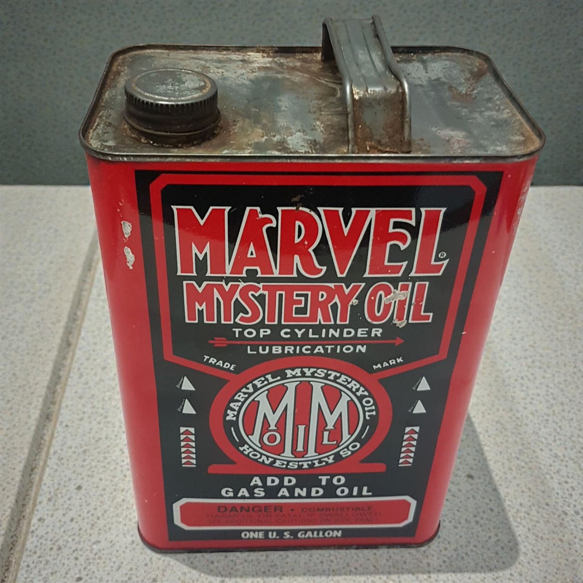 Vintage Marvel Mystery Oil can on a gray surface
