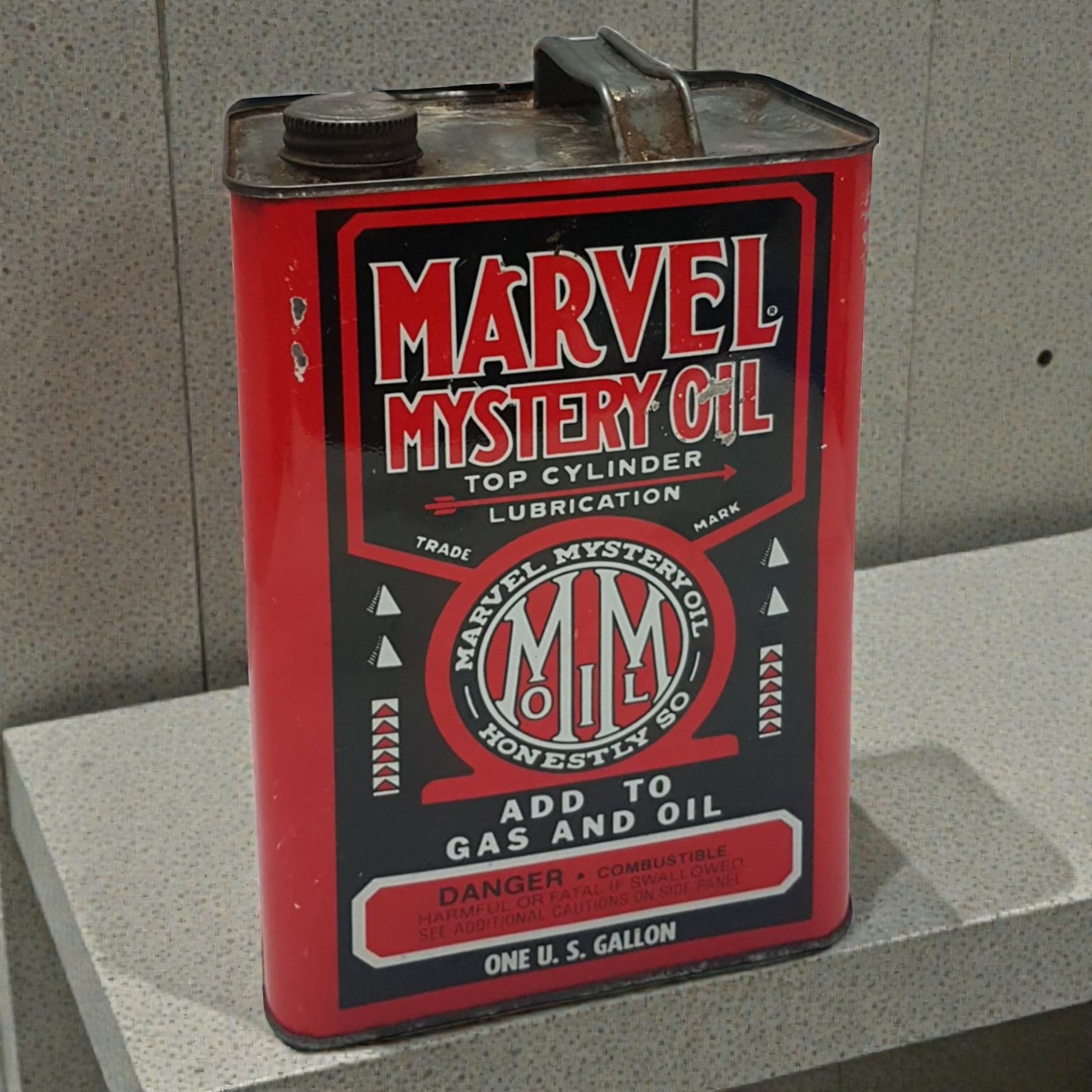Vintage Marvel Mystery Oil can on a concrete surface