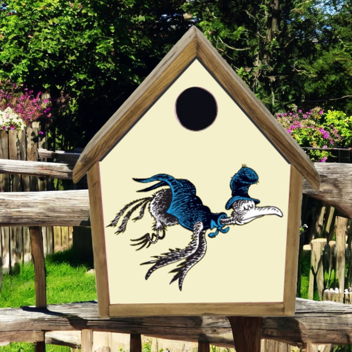Birdhouse with a dragon design on a wooden bench outdoors