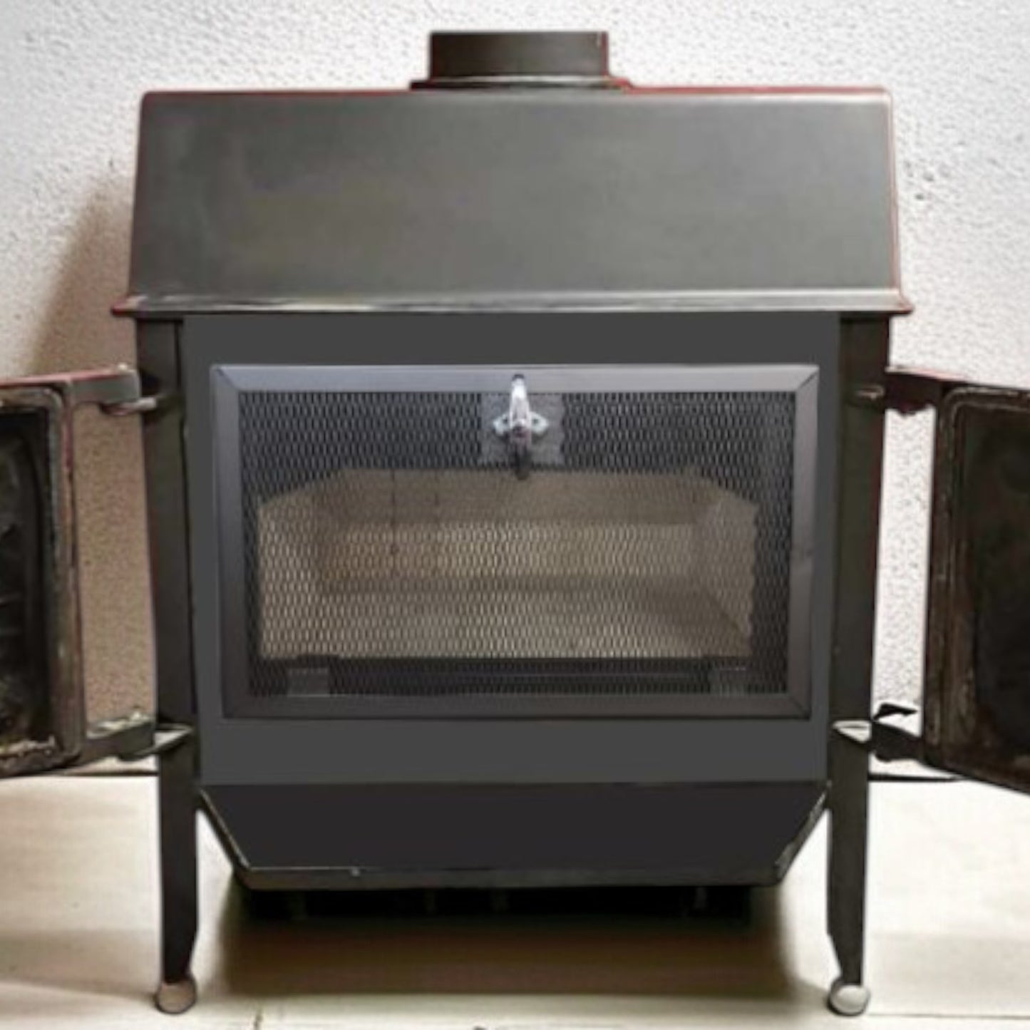 Wood-burning stove with open door on a white background