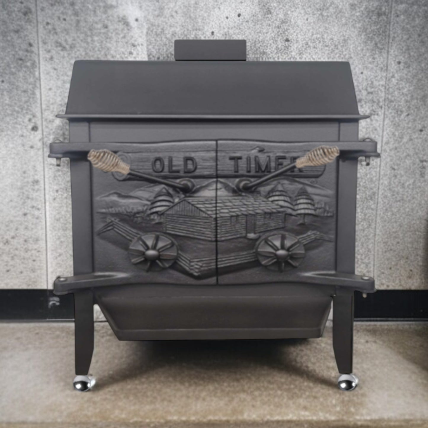 Black cast iron stove with decorative front panel on a concrete floor.