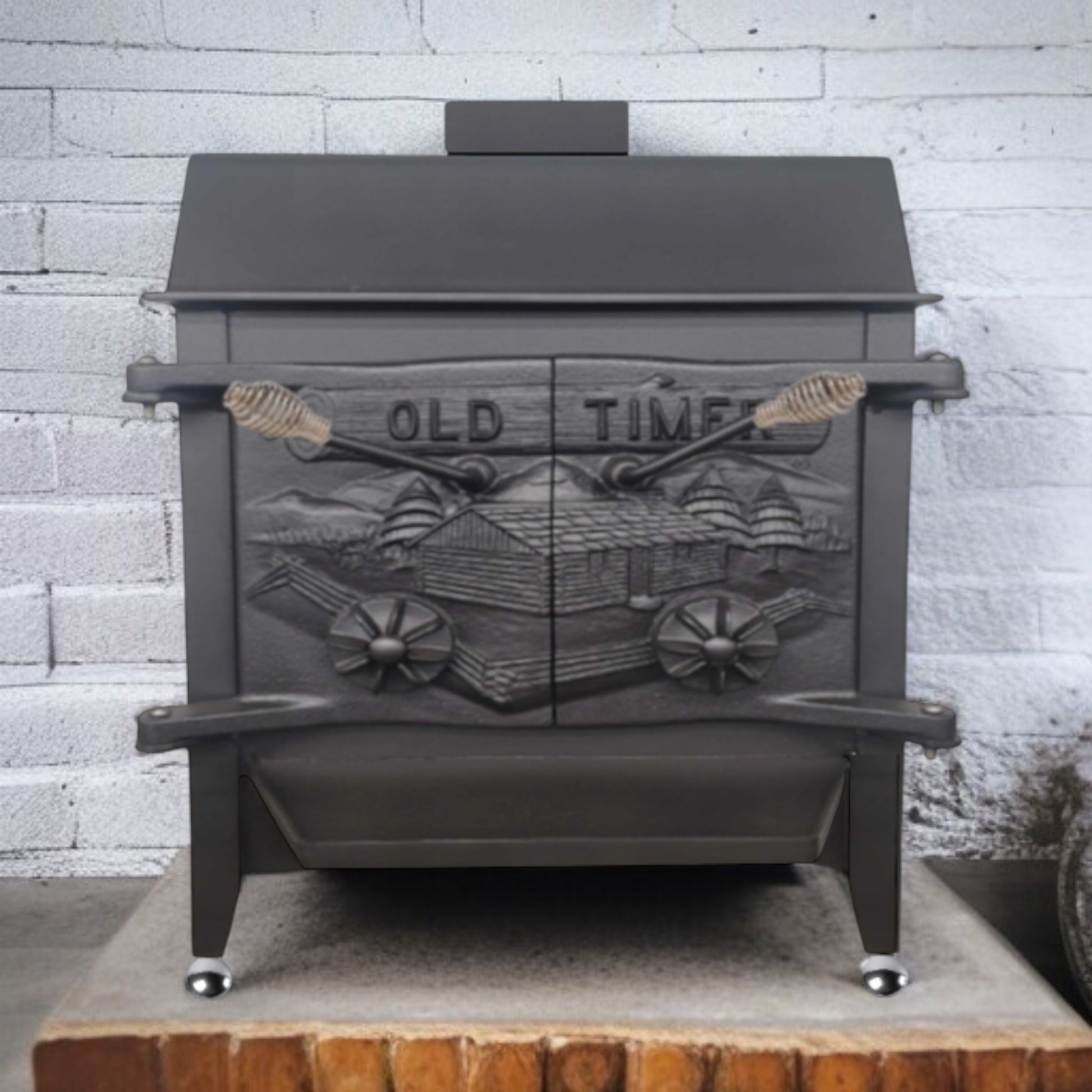 Black cast iron stove with 'Old Time' design against a white brick wall.