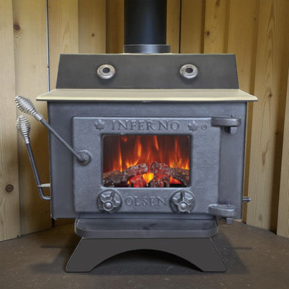 Wood stove with visible flames inside, branded 'Inferno Olsen', against a wooden background.