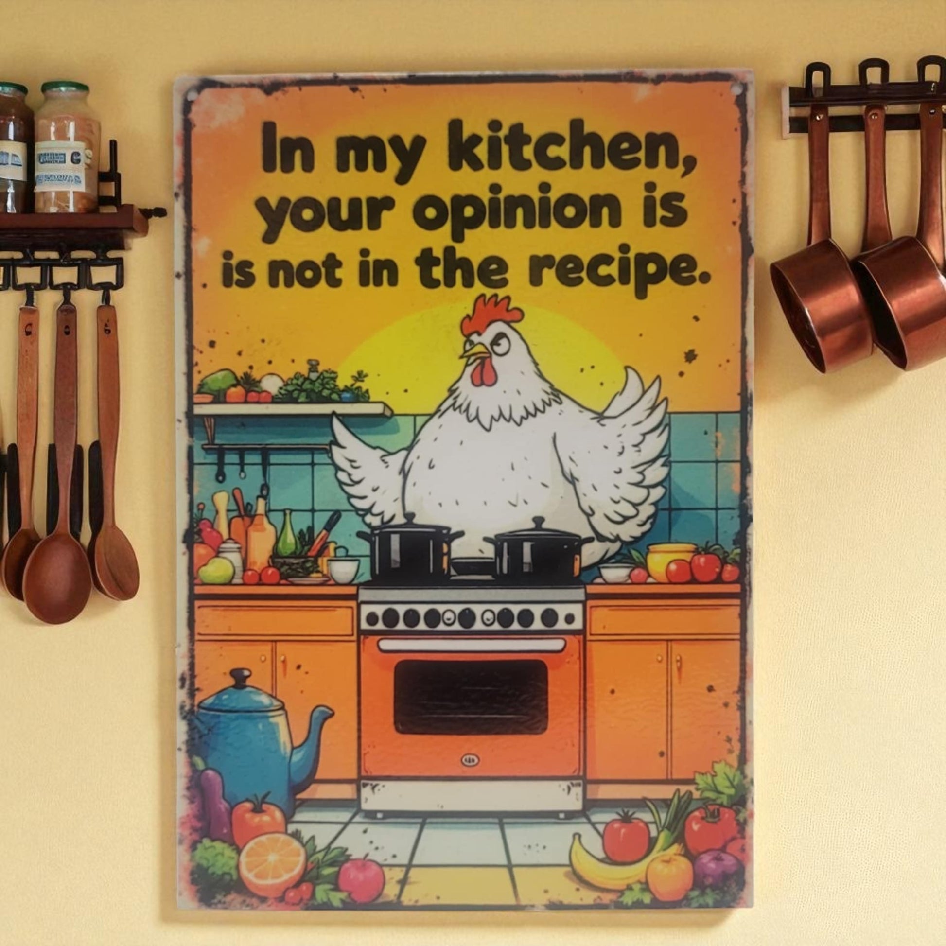 Decorative kitchen sign with a chicken and text on a yellow background, surrounded by kitchen utensils and decor.