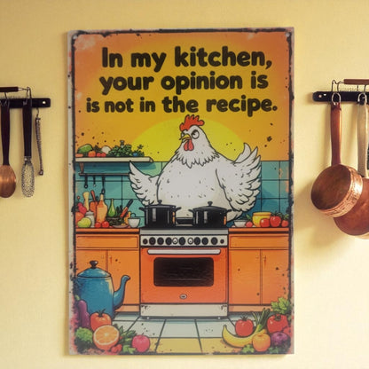 Decorative sign with a chicken in a kitchen setting and text on a yellow wall.