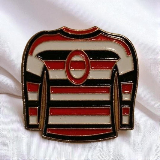 Pin with a design of a hockey jersey on a white background