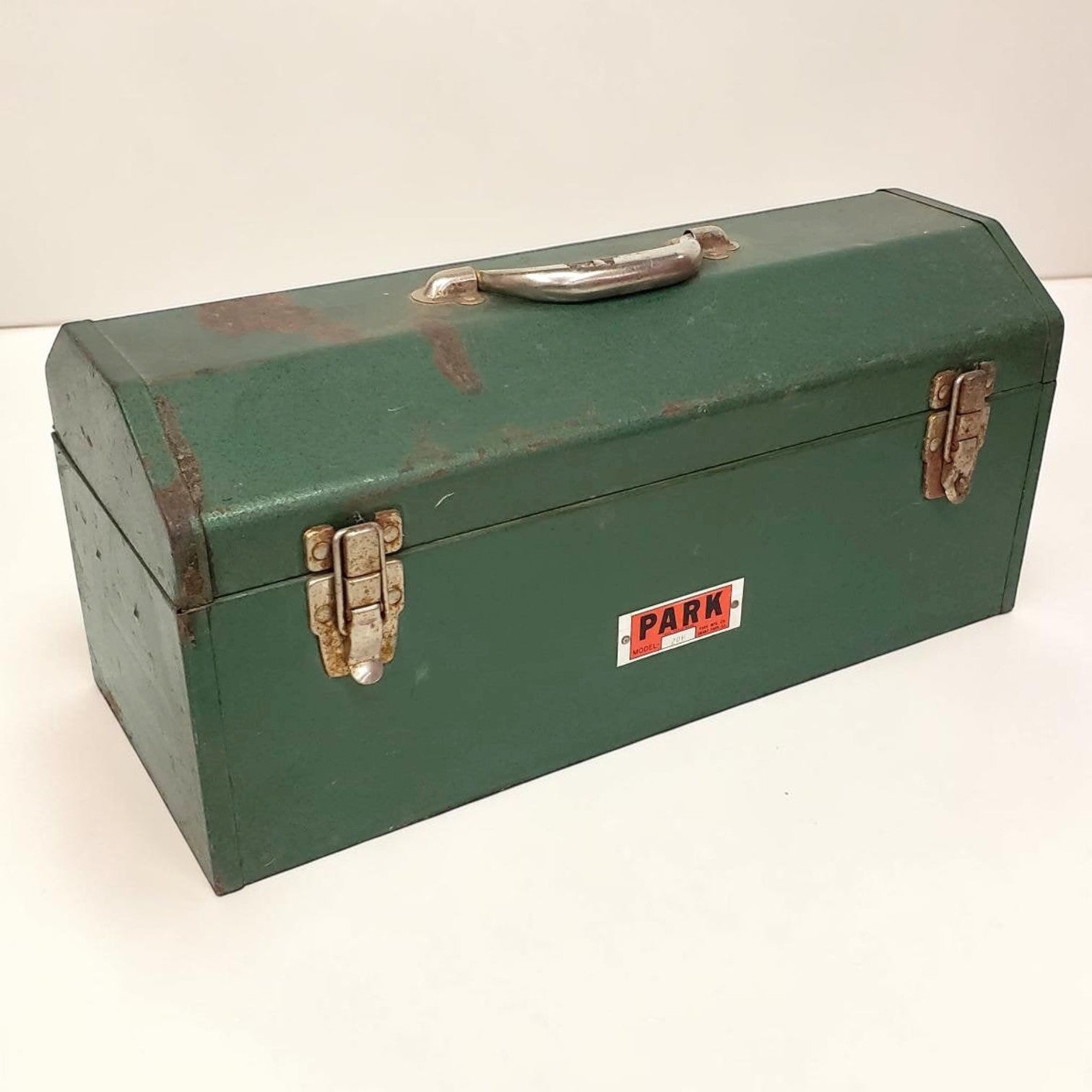 Green metal toolbox with 'PARK' label on a white background