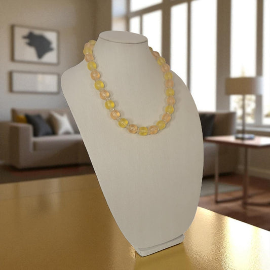 Necklace on a mannequin bust in a living room setting