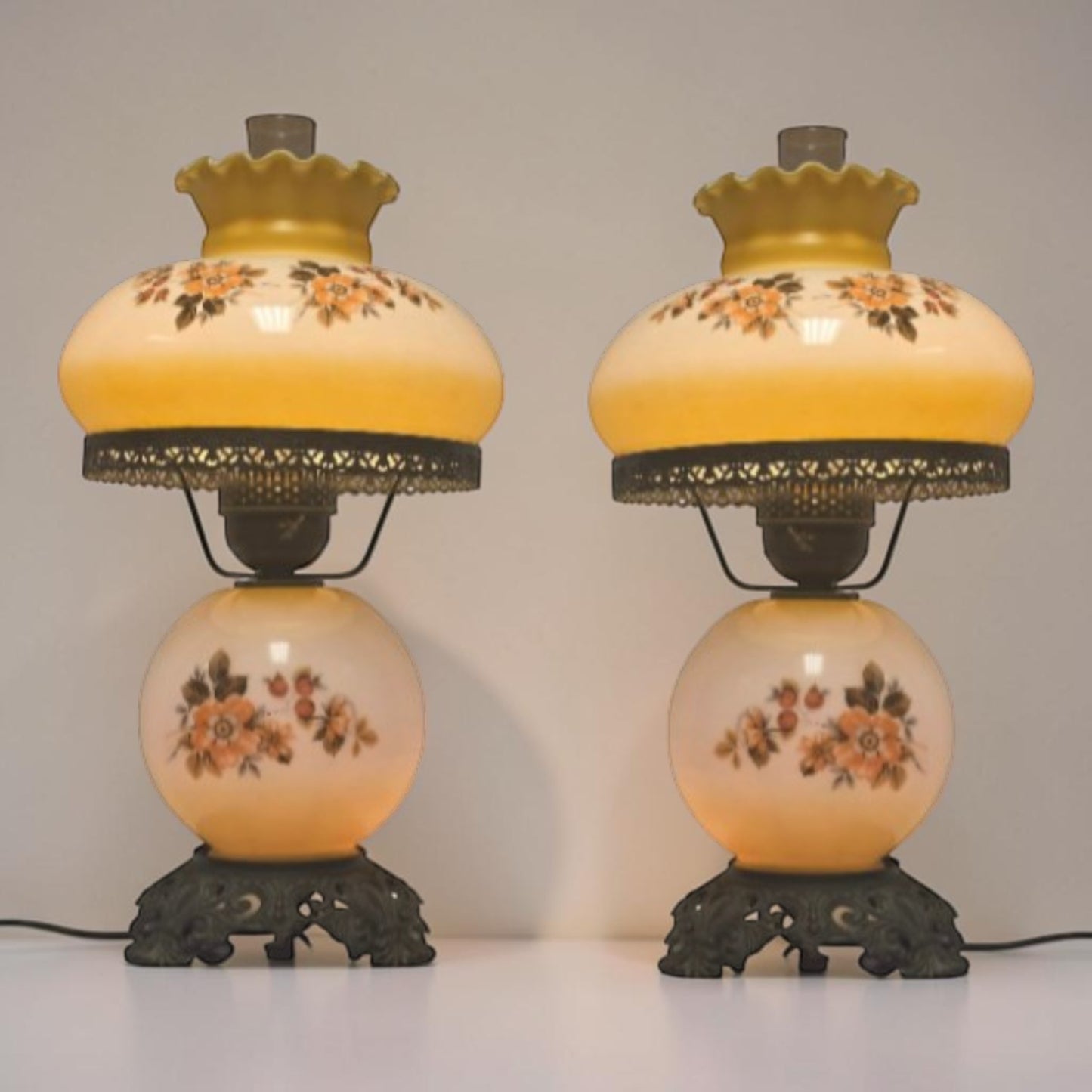 Pastel yellow Gone with the Wind hurricane lamp with peach floral decoration and tri-light lighting.