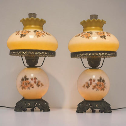 Pastel yellow Gone with the Wind hurricane lamp with peach floral decoration and tri-light lighting.