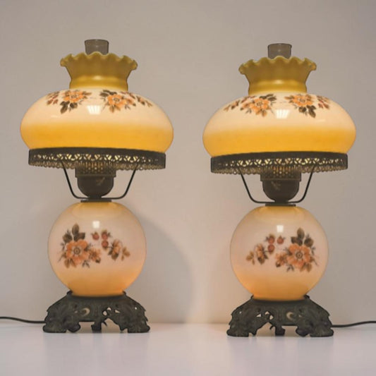 Pastel yellow Gone with the Wind hurricane lamp with peach floral decoration and tri-light lighting.