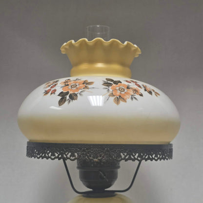 Pastel yellow Gone with the Wind hurricane lamp with peach floral decoration and tri-light lighting.