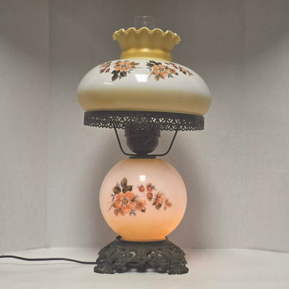 Pastel yellow Gone with the Wind hurricane lamp with peach floral decoration and tri-light lighting.