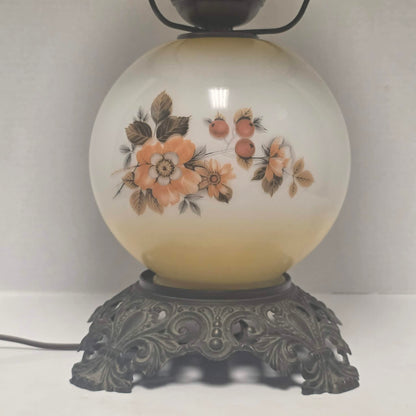 Pastel yellow Gone with the Wind hurricane lamp with peach floral decoration and tri-light lighting.