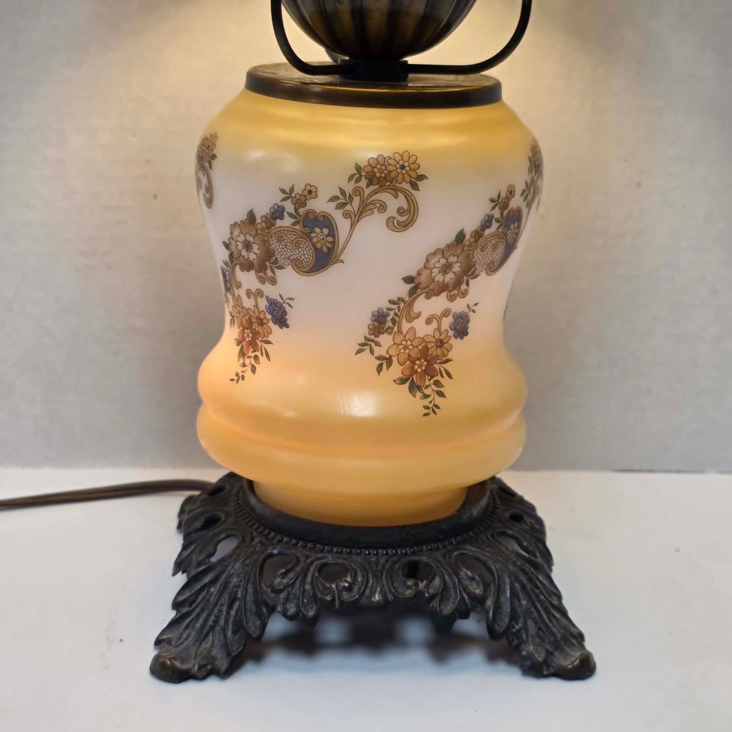 Vintage petite Gone with the Wind hurricane lamp with yellow floral decoration and tri-light feature.
