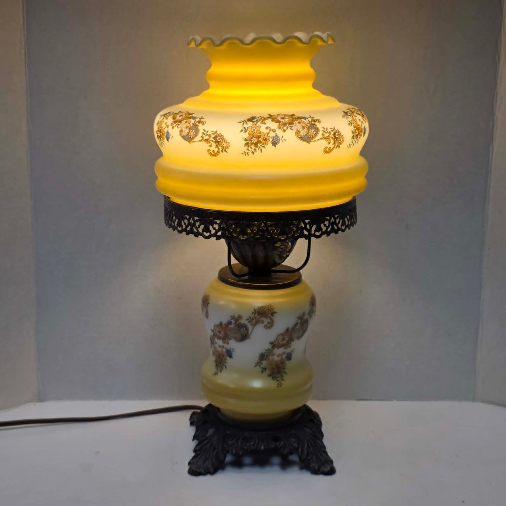 Vintage petite Gone with the Wind hurricane lamp with yellow floral decoration and tri-light feature.

