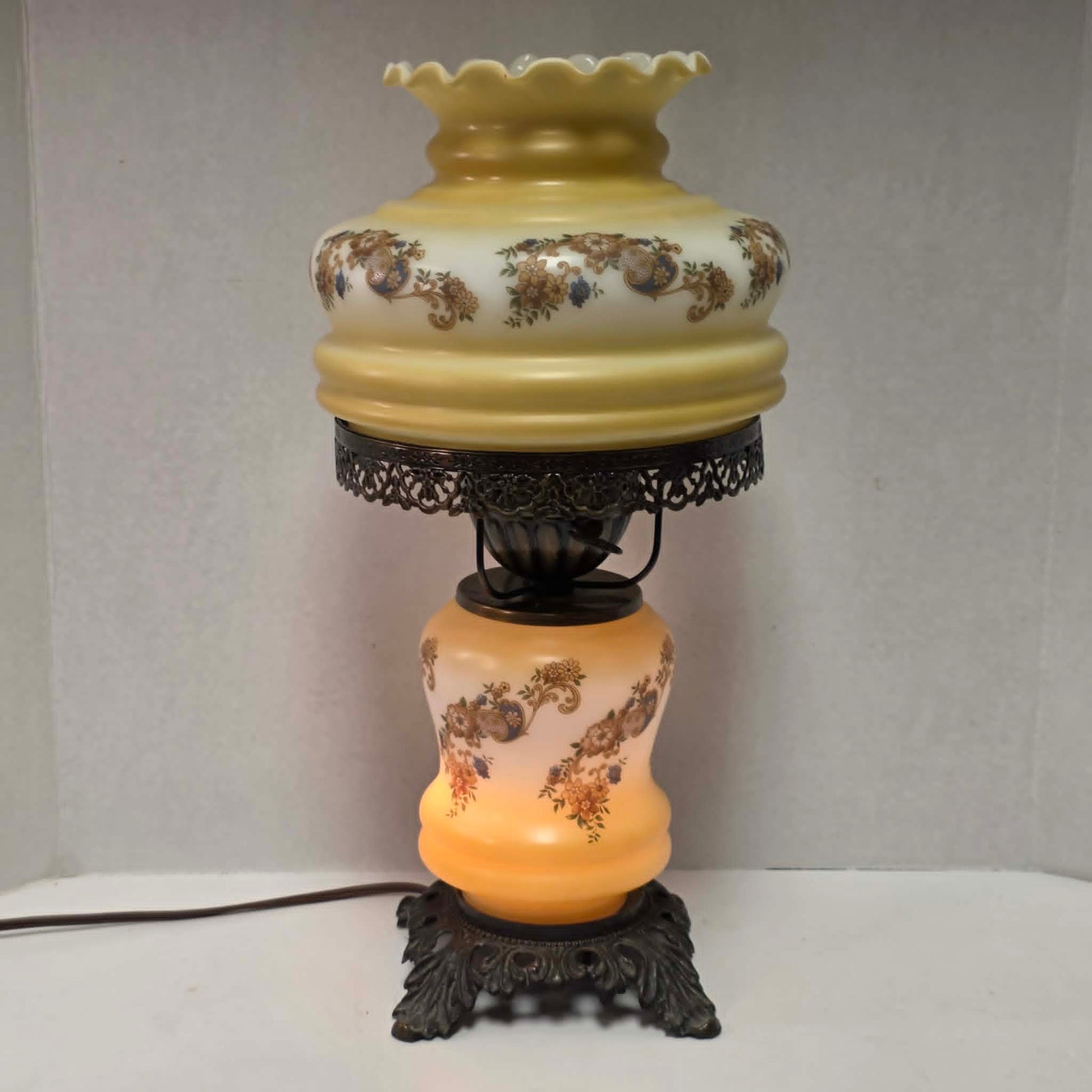 Vintage petite Gone with the Wind hurricane lamp with yellow floral decoration and tri-light feature.
