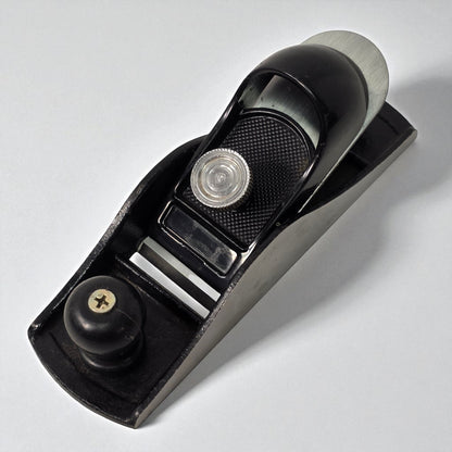Black hand plane tool on a white background