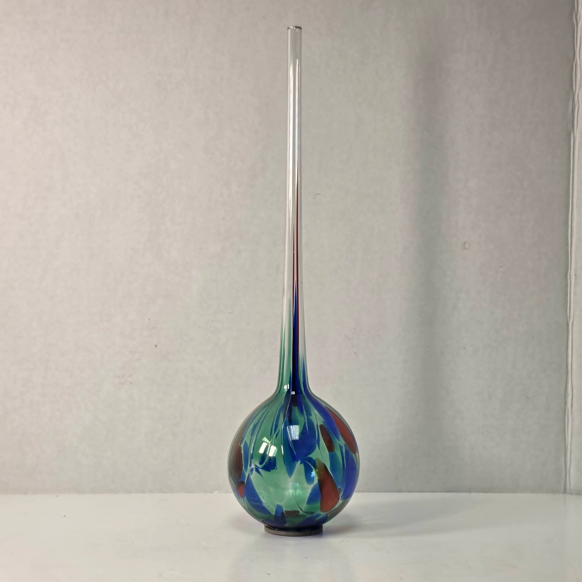 Colorful 14-inch hand-blown glass plant watering ball adding vibrant flair.