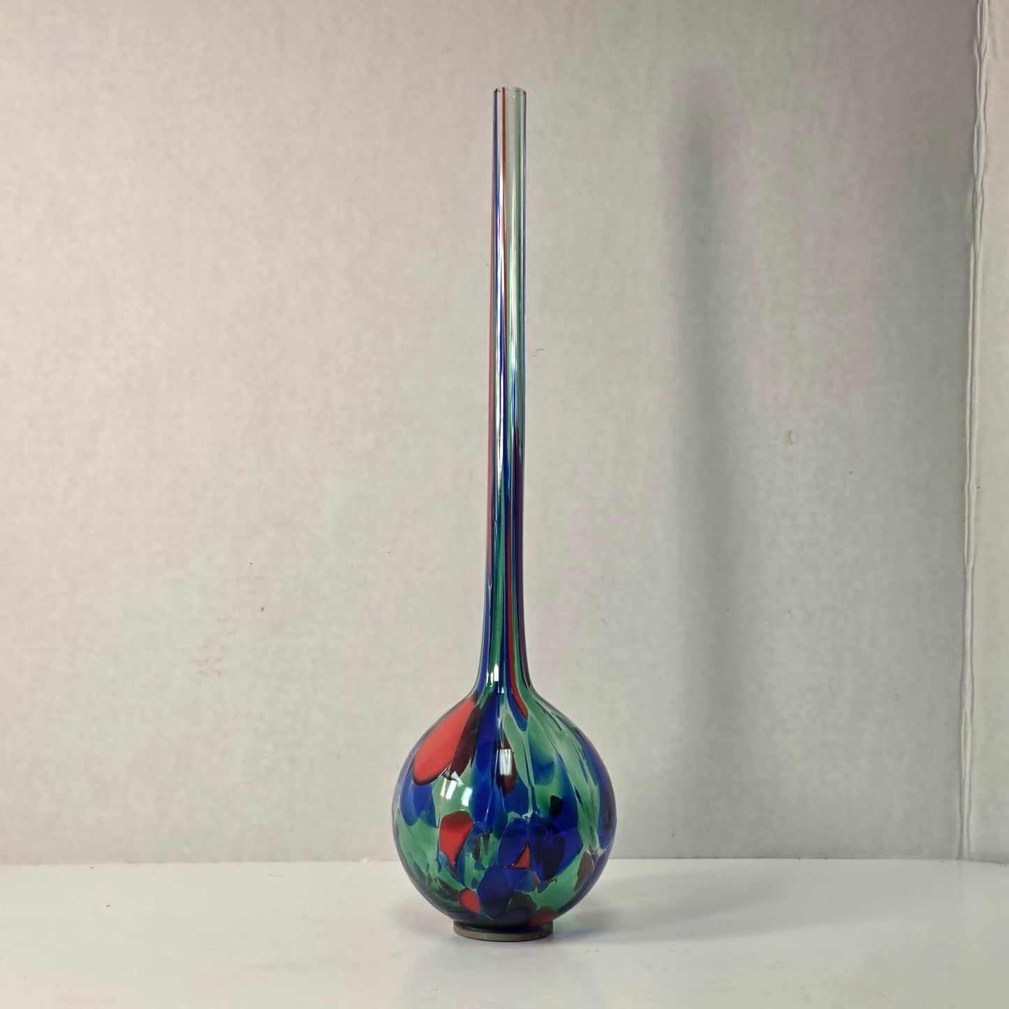 Colorful 14-inch hand-blown glass plant watering ball adding vibrant flair.