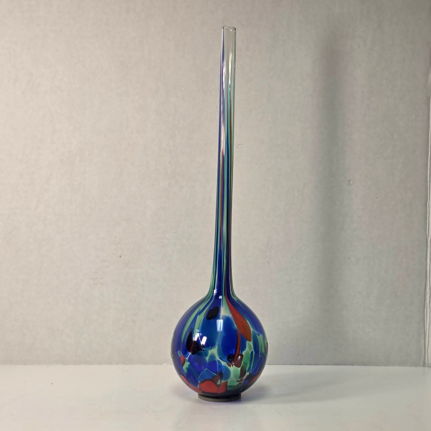 Colorful 14-inch hand-blown glass plant watering ball adding vibrant flair.