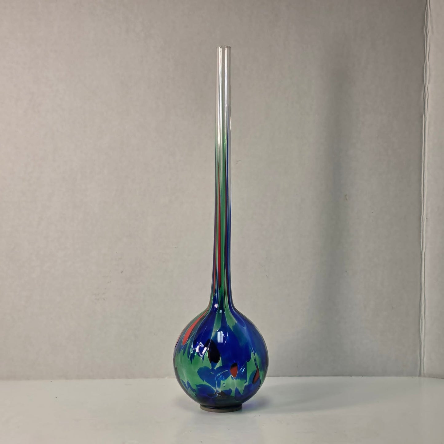 Colorful 14-inch hand-blown glass plant watering ball adding vibrant flair.