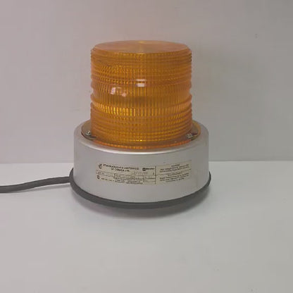 Vintage amber railroad strobe beacon light Star Headlight Model 200E industrial safety lamp with 360 degree flash and threaded base mount.