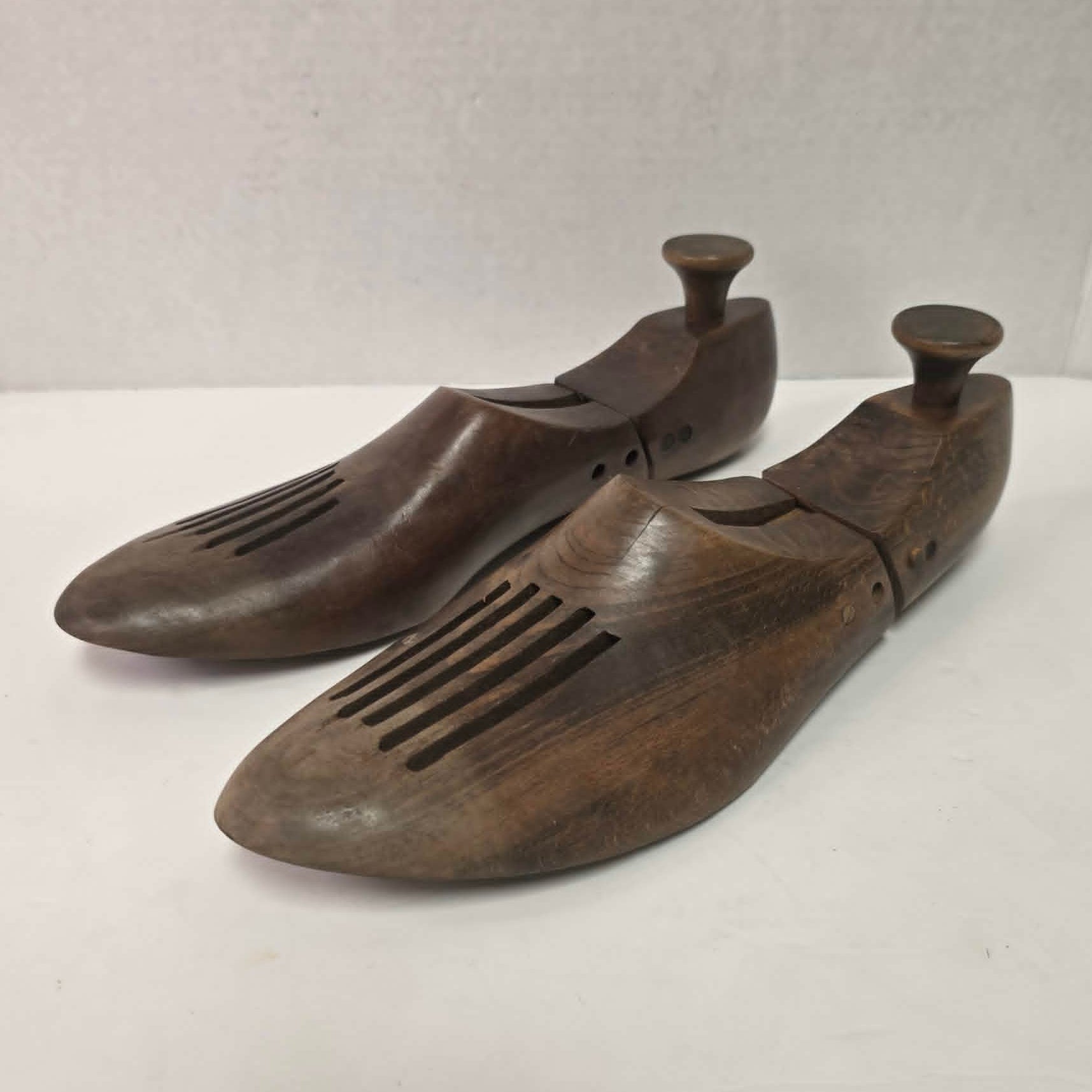 Pair of antique primitive wooden shoe stretchers with pegged construction and aged patina, early cobbler tools with articulated joint.