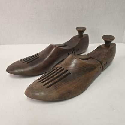 Pair of antique primitive wooden shoe stretchers with pegged construction and aged patina, early cobbler tools with articulated joint.