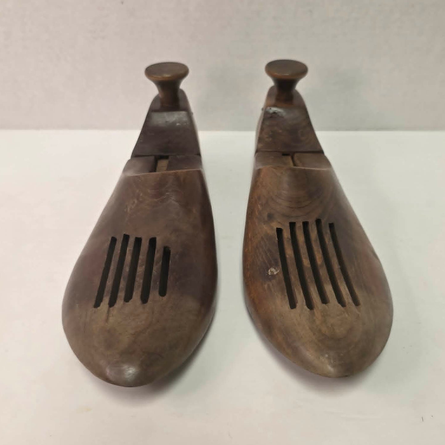 Pair of antique primitive wooden shoe stretchers with pegged construction and aged patina, early cobbler tools with articulated joint.