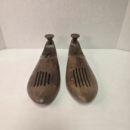 Pair of antique primitive wooden shoe stretchers with pegged construction and aged patina, early cobbler tools with articulated joint.
