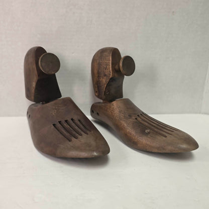 Pair of antique primitive wooden shoe stretchers with pegged construction and aged patina, early cobbler tools with articulated joint.