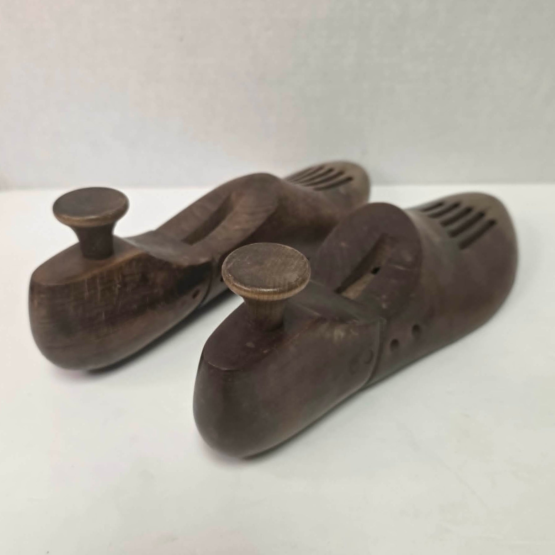 Pair of antique primitive wooden shoe stretchers with pegged construction and aged patina, early cobbler tools with articulated joint.