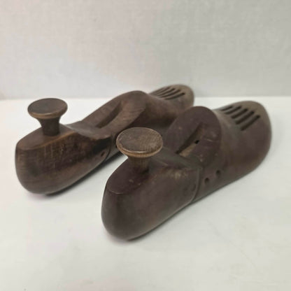 Pair of antique primitive wooden shoe stretchers with pegged construction and aged patina, early cobbler tools with articulated joint.