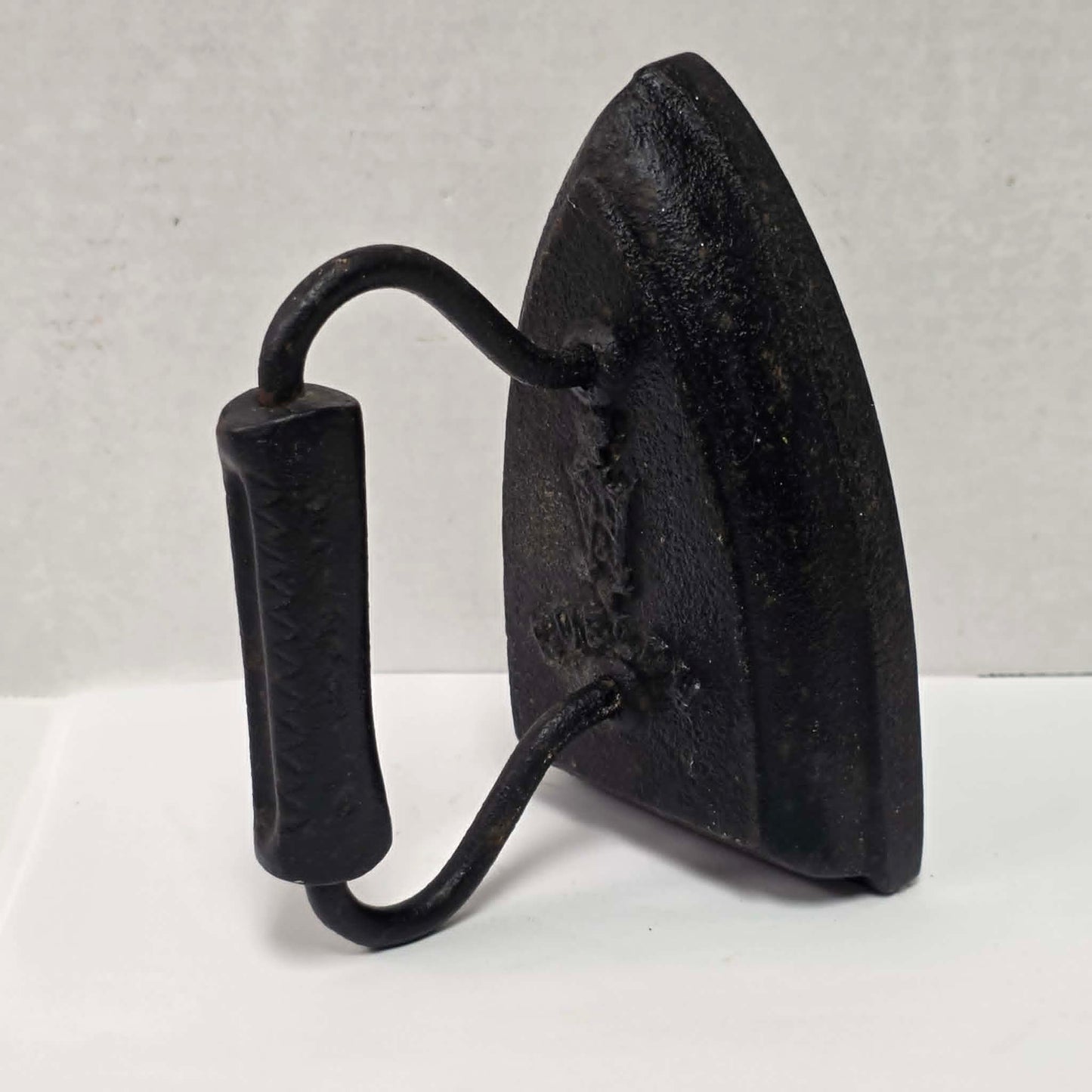 Antique cast iron tailor's press iron made in Guelph Ontario with beautifully formed handle.
