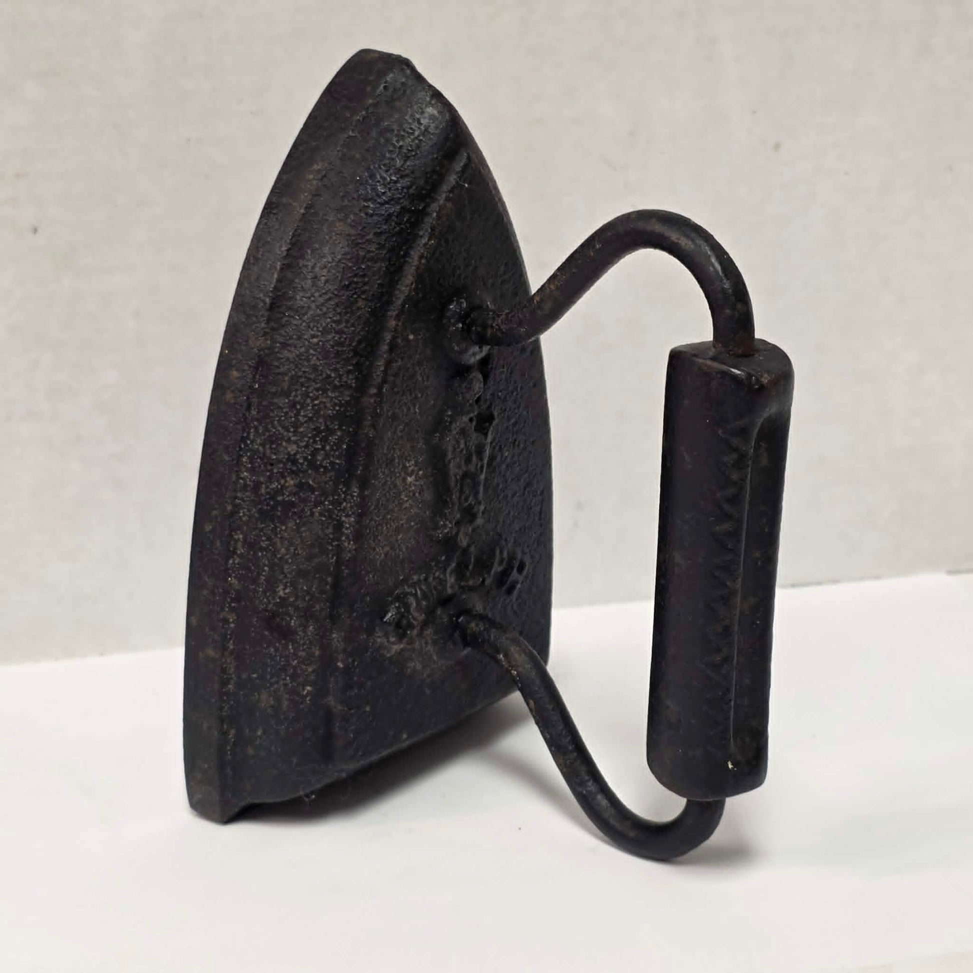 Antique cast iron tailor's press iron made in Guelph Ontario with beautifully formed handle.
